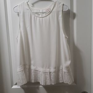 White sleeveless ruffle bottom blouse